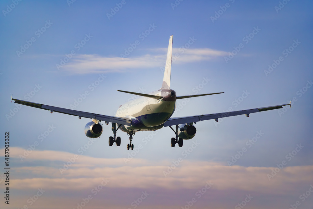Fototapeta premium Departing view of an approaching passenger airplane preparing to land at the airport.