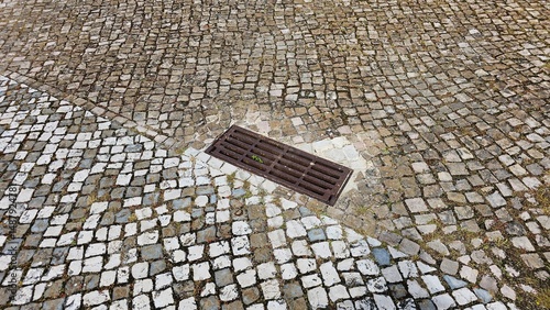 Old Cobblestone Pavement with Drain – Urban Texture and Pattern Detail