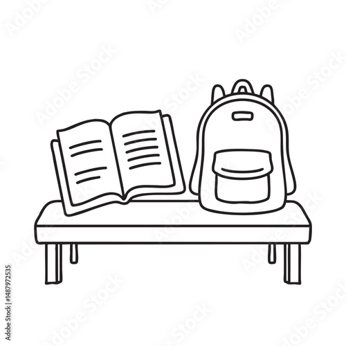 A textbook open on a bench beside a backpack photo