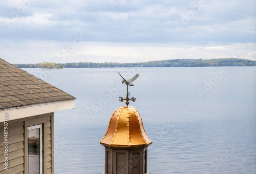 Weathervane sitting on copper dome overlooking the St. Lawrence river, daytime, nobody
