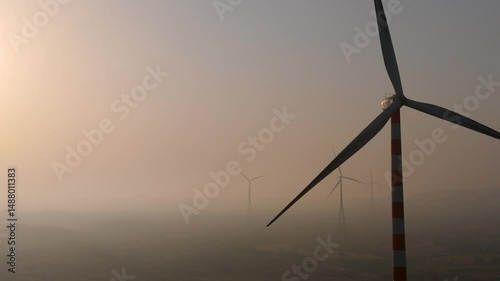 Beautiful evening view of wind turbine near evening sun.  Renewable energy.