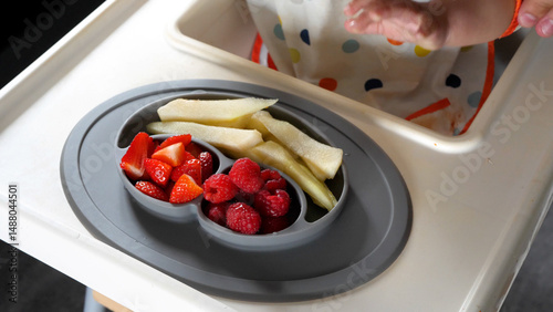 Plate full of fruit prepared for a baby to eat his meal, baby led weaning method