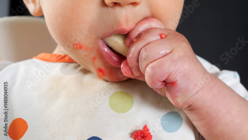 Fotografía Slow motion clip of a baby eating a piece of pear, baby led weaning method