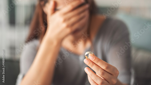 Woman taking off her wedding ring