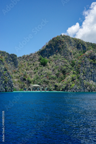 Fototapeta Naklejka Na Ścianę i Meble -  A private and luxury resort hideaway in the middle of Coron, Palawan islands. Face the wide ocean and has a beautiful mountain range in the background. The most perfect summer holiday in Asia