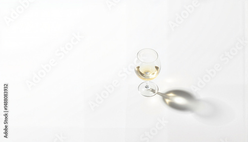 Elegant wine glass casting shadow on white background, minimalist design