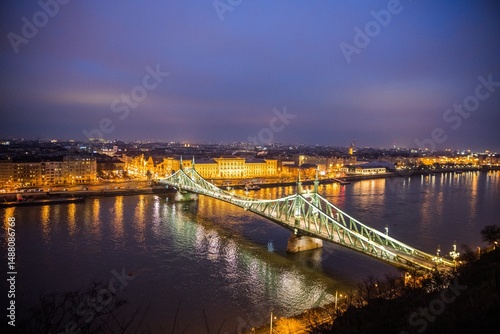 Photography Budapest, Hungary - January 22 2023: Liberty Bridge (Szabadság híd) illuminated at dusk, spanning the Danube River in central Budapest