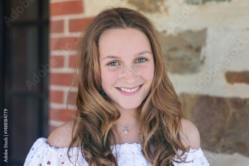 portrait of a pretty teenager with long curled hair