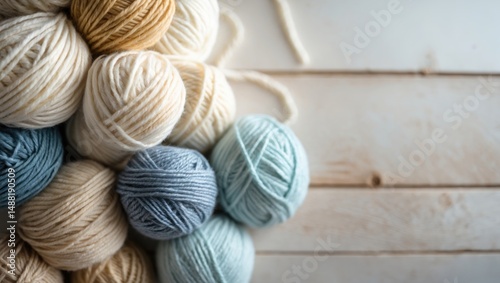 Twisted wool and cotton balls placed on aged rustic table, overhead perspective