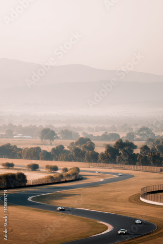 panoramic view of racetrack emphasizing sharp turn bathed in soft warm light