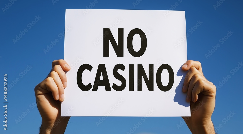 Protest sign advocating against casinos held in clear blue sky Protest sign advocating against casinos held in clear blue sky