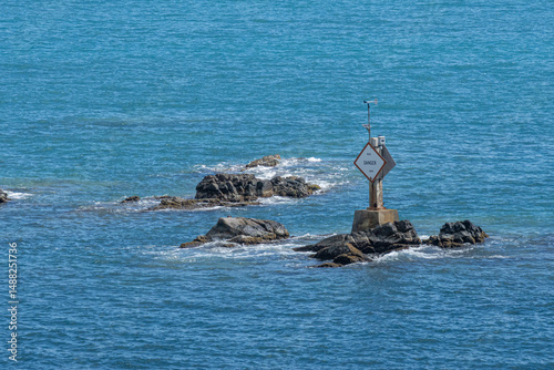 Sign warning of dangerous rocks in seaport entrance