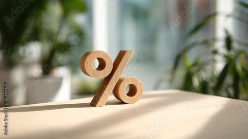 Wooden percentage sign on a table with plants in the background.