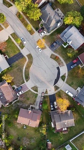 Aerial view on top of suburban neighborhood, A vibrant aerial shot of a residential suburban neighborhood showcasing houses with backyards, driveways