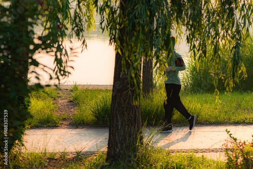Luannan County, Hebei Province, China - May 2024: People taking morning walks and doing exercises in urban parks to exercise their bodies photo