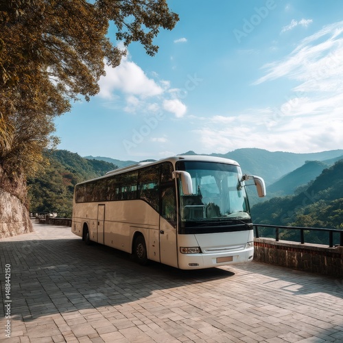 Modern Tour Bus Parked in Scenic Mountain Landscape with Lush Greenery, Blue Skies, and Serene Pathway for Travel Enthusiasts and Adventurers
