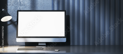Blank computer screen mockup on modern desk with keyboard and lamp against dark striped wall background for design and branding concepts. 3D Rendering