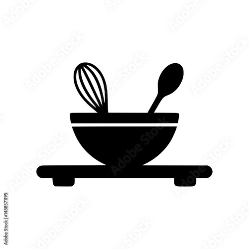 Kitchen utensils in a bowl on a platform