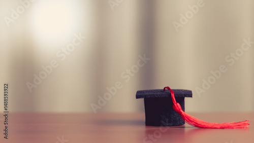 Graduation cap on wooden ta...