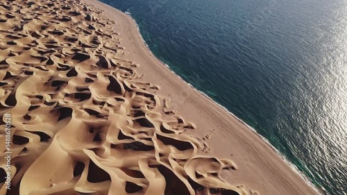 sand dunes meet the sea. A breathtaking landscape with textured sand and the vast ocean