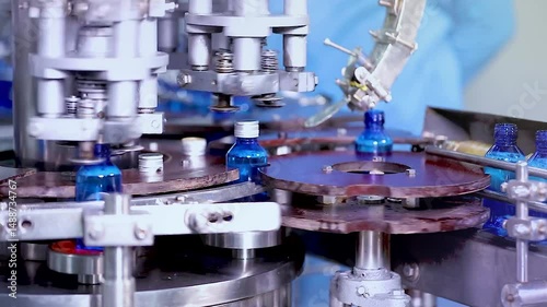Pharmaceutical manufacturing line for liquid medicine production, automatic bottle filling machine for syrup, sanitizer, or gel in plastic bottles at sterile industrial packaging facility