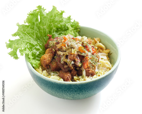 Isolated Crispy Fried Chicken Bowl With Sambal Matah and Fresh Lettuce and Savory Slaw Served in a Blue Ceramic Dish