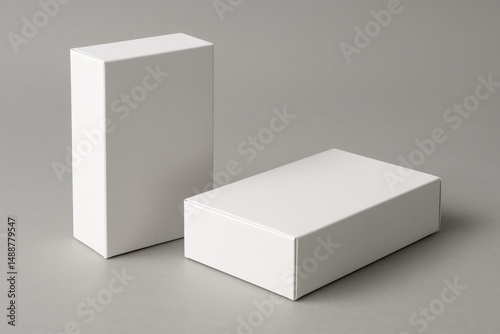 Minimalist Boxes: Two pristine, white boxes in a stark, studio-style setting, a perfect backdrop for product display or branding mockups, exuding simplicity and elegance. photo