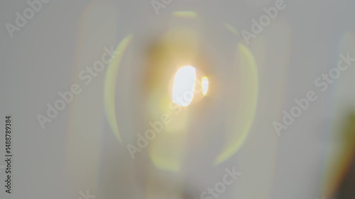 A bright beam of light pierces through a foggy atmosphere, creating a dramatic visual effect.