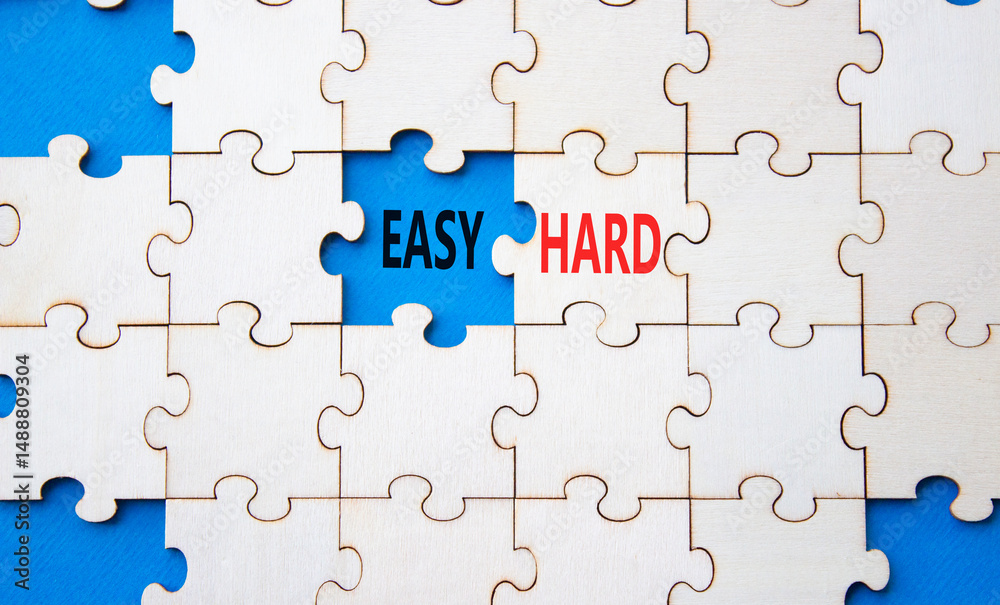Easy or Hard symbol. Concept word Easy or Hard on wooden puzzle. Beautiful blue background. Business and Easy or Hard concept. Copy space Easy or Hard symbol. Concept word Easy or Hard on wooden puzzle. Beautiful blue background. Business and Easy or Hard concept. Copy space
