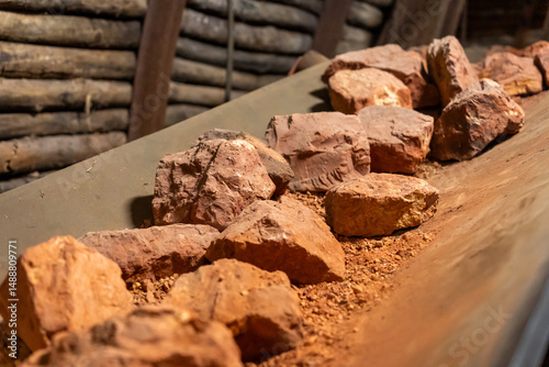 Bauxite rocks on conveyor in mining tunnel