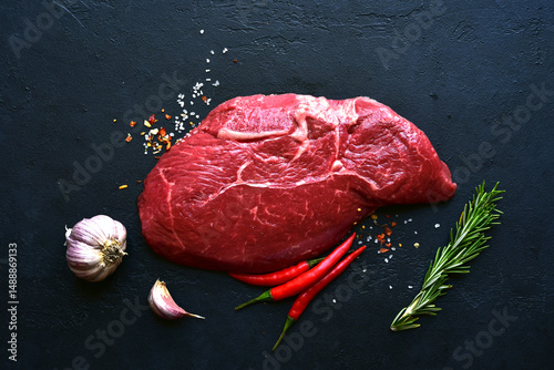 Raw organic marbled beef steak with ingredients for cooking . Top view with copy space.
