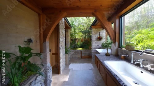 Interior view of a bathroom with wooden beams and a large window overlooking lush greenery outside