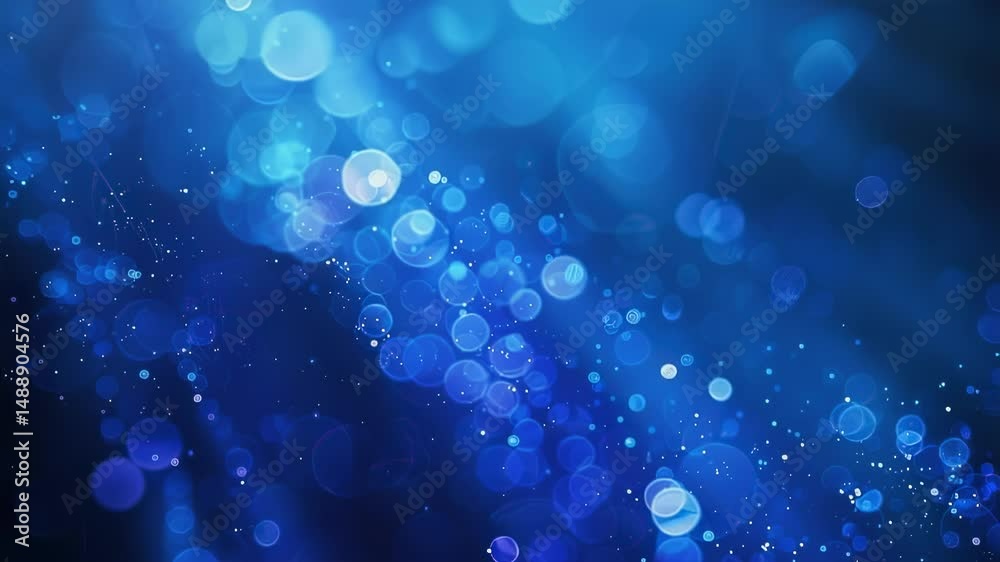 Abstract blue bokeh background with sparkling particles, creating a dreamy and ethereal atmosphere
