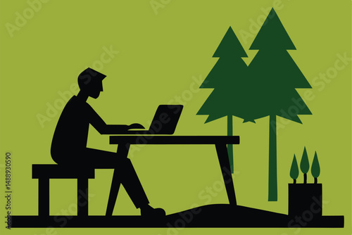 Silhouette of a person working on a laptop at a desk in an office
