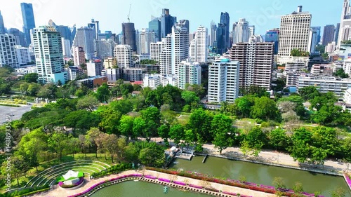 Aerial Shot Of Modern Office Buildings In City Against Clear Sky, Drone Ascending Forward On Sunny Day - Bangkok, Thailand