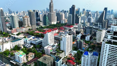 Aerial Backward Ascending Shot Of Modern Skyscrapers In Residential City Against Clear Sky - Bangkok, Thailand