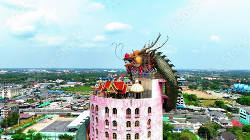 Aerial Shot Of Wat Sam Phran Temple In City, Drone Flying Backwards Over Green Trees - Khlong Mai, Thailand
