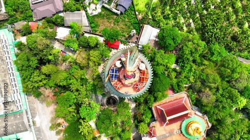 Aerial Top Panning Upward Shot Of People On Top Of Dragon Temple Amidst Green Trees - Khlong Mai, Thailand
