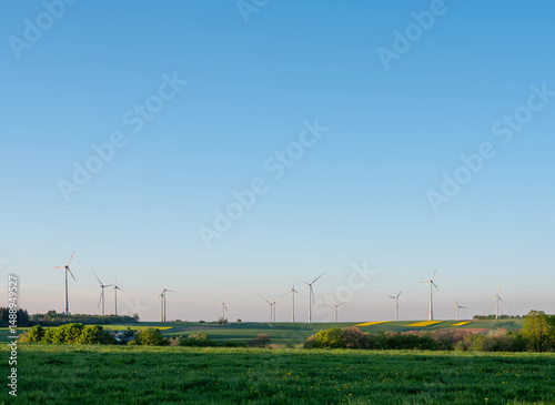wind turbines under blue sky in german saarland in spring