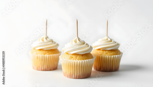 Three Vanilla Cupcakes Topper Mockup. 3 cupcake with wooden toothpick in white background Copy space for your design here. Blank mockup for advertising and promotions, dramatic atmosphere. White ton