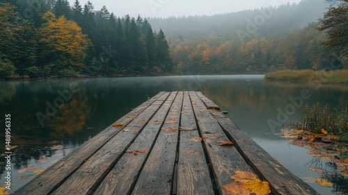 Weathered Wooden Pier Extending into Calm Autumn Lake