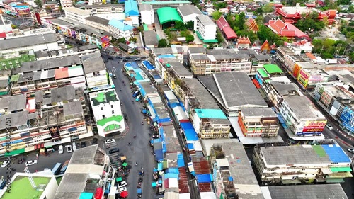 Aerial Forward Ascending Shot Of Roofed Buildings In Residential City - Khlong Mai, Thailand