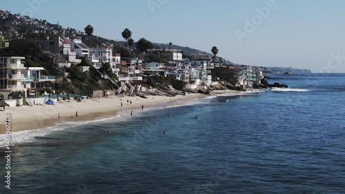 Aerial: Drone Panning Beautiful Shot Of Buildings In Residential City By Beach On Sunny Day - Laguna Beach, California