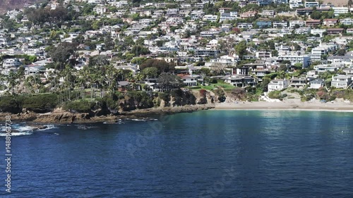 Aerial Panning Scenic Shot Of Buildings In City On Cliff During Sunny Day - Laguna Beach, California