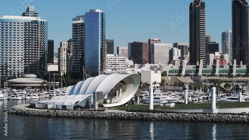 Aerial: Drone Panning Shot Of Famous Live Music Venue By Modern Buildings, Drone Flying Over Sea On Sunny Day - San Diego, California