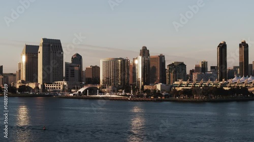 Aerial Shot Of Famous The Rady Shell By Modern Buildings In Residential City, Drone Flying Forward Over Rippled Sea During Sunset - San Diego, California