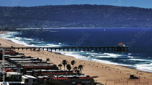 Aerial Lockdown Shot Of Manhattan Beach Pier In Residential City On Sunny Day
