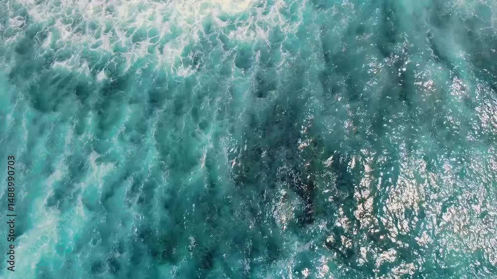 Footage shows aerial ocean surface with waves rolling gently, illustrating the dynamic movement across the Earth's large saltwater body.