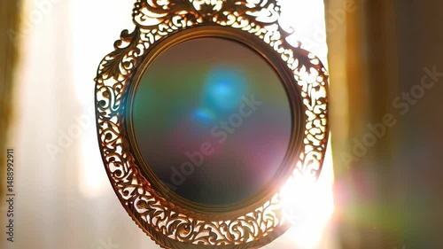 Elegant ornate golden handheld mirror reflecting vibrant rainbow light against soft background, luxurious vintage aesthetic