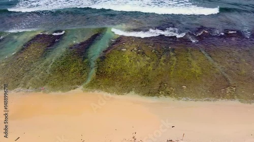 Drone shows Cudgen Creek flowing into the ocean at Kingscliff, Australia. The meeting of fresh and salt water forms a dynamic estuarine ecosystem.